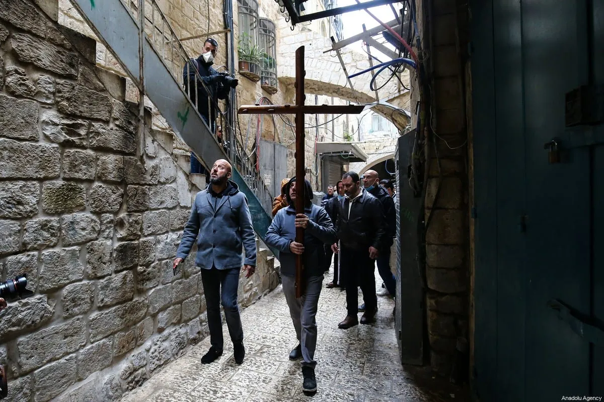 Christians walk along Via Dolorosa on quiet Good Friday due to the restrictions on public gatherings amid the coronavirus (Covid-19) in Jerusalem on April 10, 2020. [Mostafa Alkharouf - Anadolu Agency]