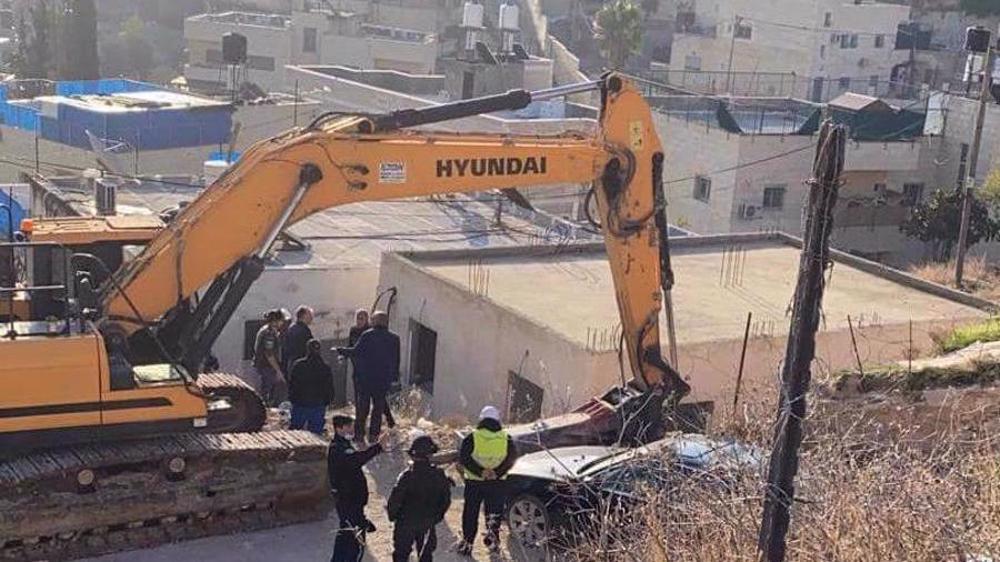 An Israeli bulldozer prepares to demolish a Palestinian house in Jabal al-Mukaber neighborhood of the occupied East al-Quds on December 29, 2021. (Photo by Wafa news agency)