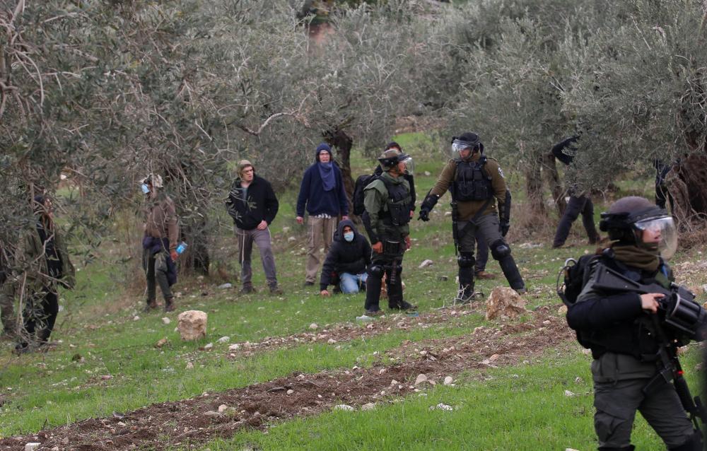 Israeli settlers, protected by Israeli occupation forces, seized Palestinian lands in Yanun village, south of the occupied West Bank city of Nablus.