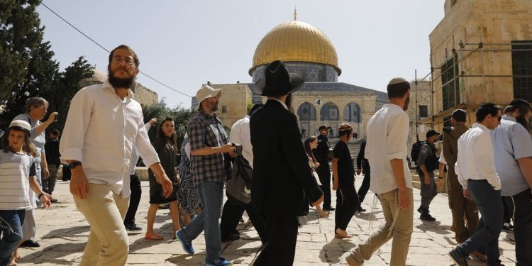 Israeli settlers, under Israeli police protection, are seen as they raid Al-Aqsa Mosque Compound in Jerusalem on 2 June 2019 (Photo credit: Ahmad Gharabli/AFP/Getty Images)