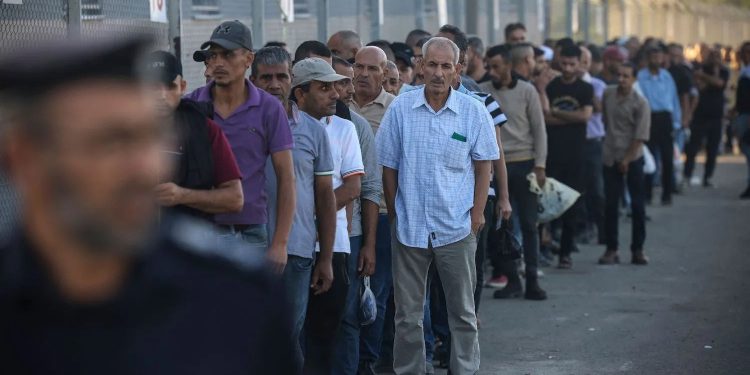 Palestinian workers gather at the Erez Crossing between Israel and Gaza on Sept. 28. MOHAMMED ABED/AFP VIA GETTY IMAGES