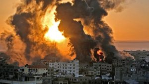A fire rages at sunrise in Khan Yunish following an Israeli airstrike on targets in the southern Gaza strip, early on May 12, 2021.