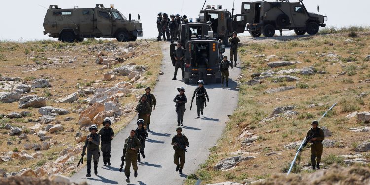 Israeli troops take position during clashes between Palestinians and Israeli troops after Israeli machinery demolish a school near Bethlehem in the Israeli-occupied West Bank May 7, 2023. REUTERS/Mussa Qawasma