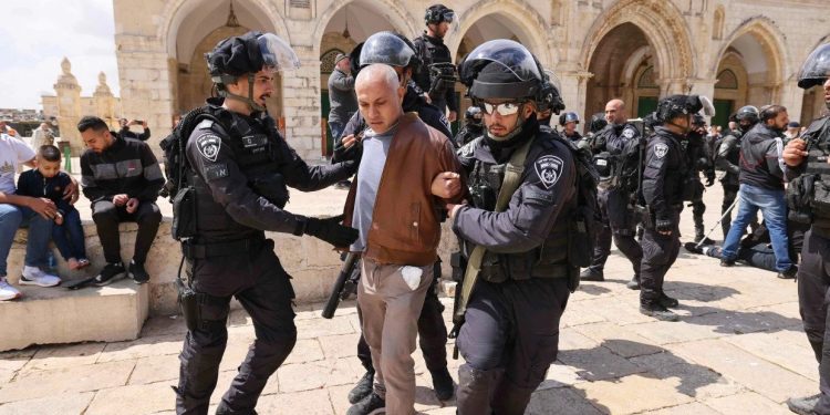 Israeli police detain a man during clashes on Thursday following a visit by a group of Jewish people at the al-Aqsa mosque compound in Jerusalem. Ahmad Gharabli / AFP - Getty Images