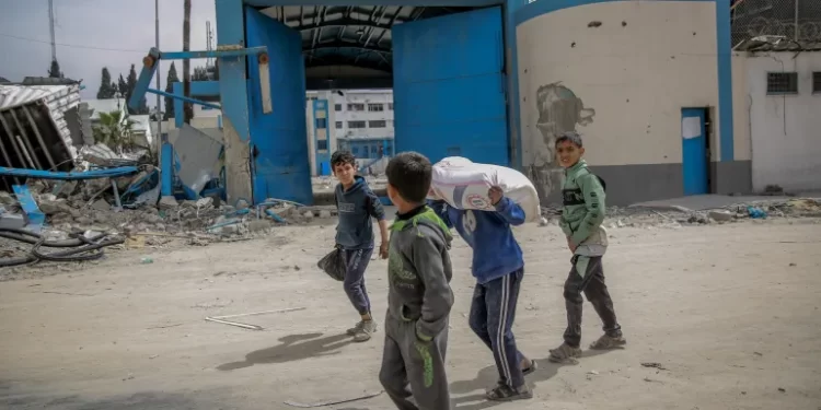 Gaza children are waiting to receive flour amidst Israel's closure of Aids